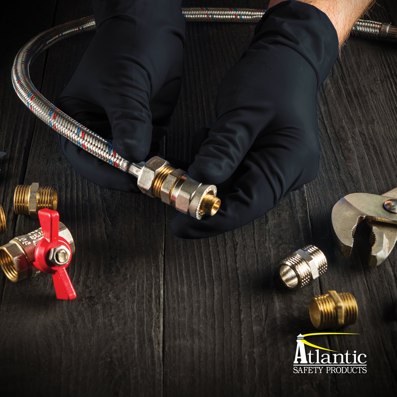 hands wearing black nitrile gloves holding plumbing parts