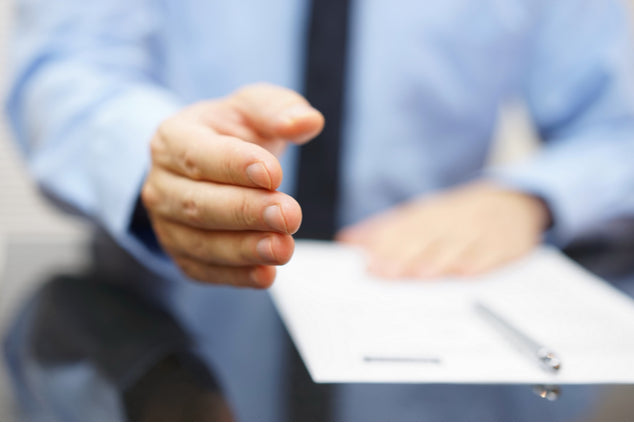 a business man extending their hand for a handshake.